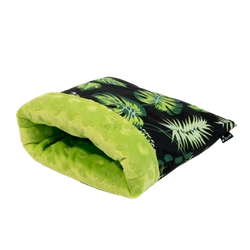 Schlafsack in Blättern auf schwarzem Hintergrund